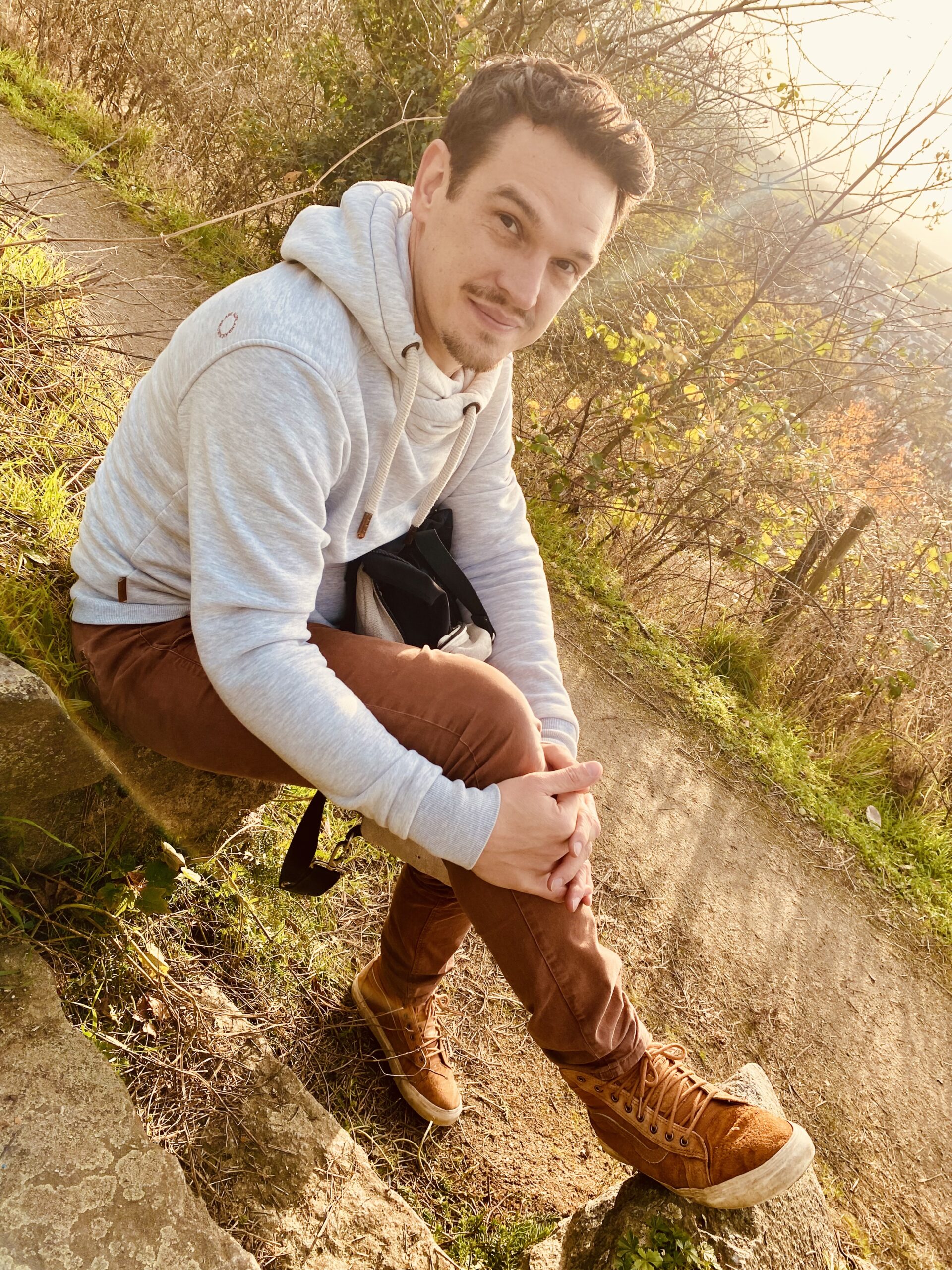 A man sitting outside on a sunny day